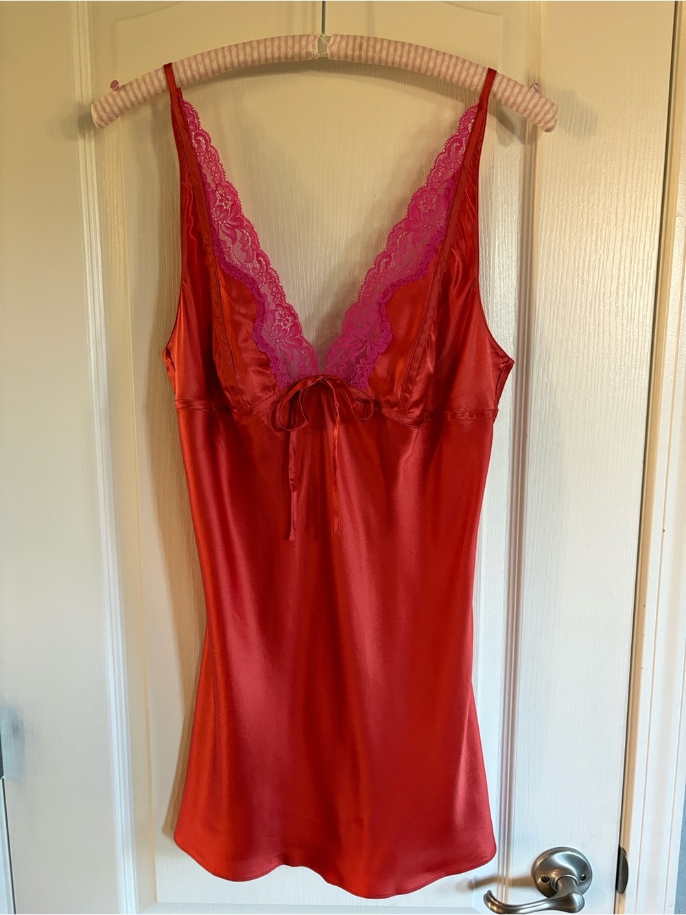 Victoria’s Secret silk slip in red/orange with pink lace trim.